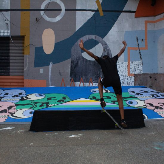 skate park A younger skater lands a flip in front of a mural in the Skate Alley.