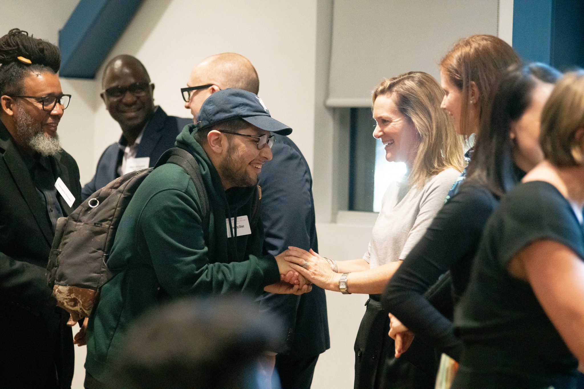 FREDDY DIAZ AND MARY CULLER SHAKE HANDS. PHOTO AMY NICOLE / ACRONYM