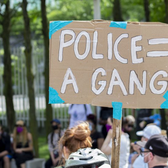 DEFUND THE POLICE A PROTESTER HOLDING A SIGN IN DETROIT. PHOTO JOHN BOZICK