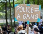 DEFUND THE POLICE A PROTESTER HOLDING A SIGN IN DETROIT. PHOTO JOHN BOZICK