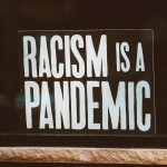 black and white racism sign