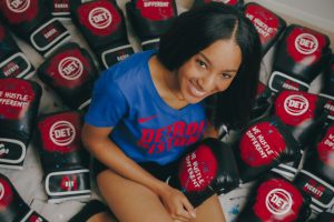 ALLISON SIMS WITH HER DETROIT PISTONS MERCH