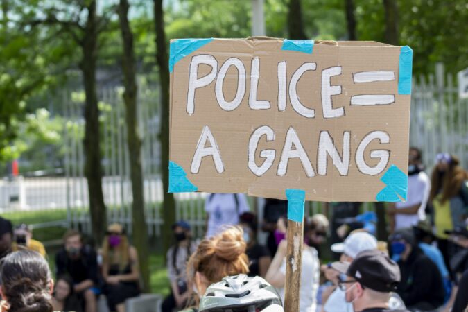 DEFUND THE POLICE A PROTESTER HOLDING A SIGN IN DETROIT. PHOTO JOHN BOZICK