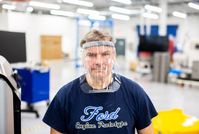 LOCKDOWN // A WORKER WEARS A PROTOTYPE OF A 3D-PRINTED MEDICAL FACE SHIELD PRINTED AT FORD’S ADVANCED MANUFACTURING CENTER. PHOTO FORD MOTOR COMPANY