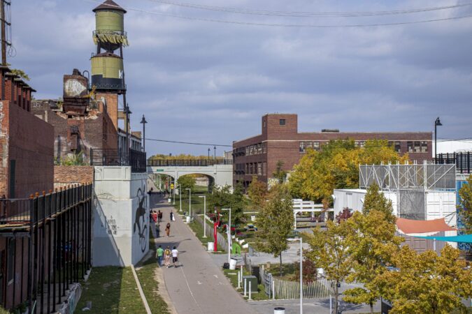 PEOPLE WALK ON THE THE DEQUINDRE CUT GREENWAY IN DETROIT, A TRANSPORTATION SYSTEM. PHOTO JOHN BOZICK