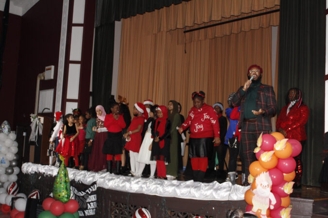 STUDENTS PERFORMING A MISER SISTER'S CHRISTMAS