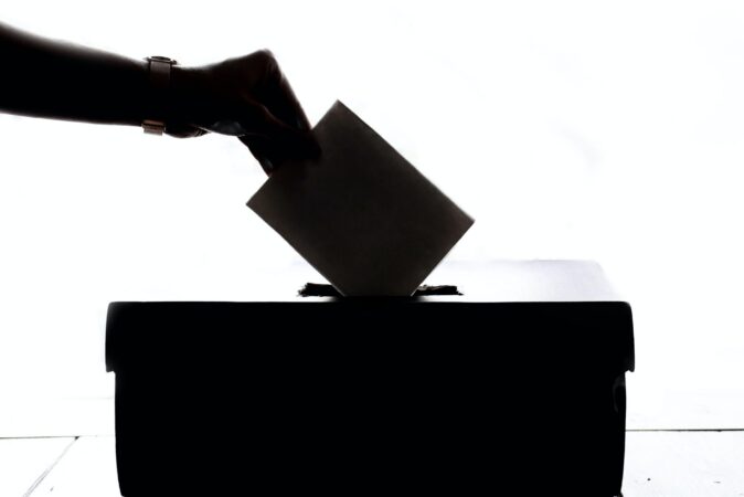 person putting envilope in the voting box // will the republican party make it harder to vote? // PHOTO BY ELEMENT5 DIGITAL ON UNSPLASH